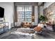 This modern living room has exposed brick, a cowhide rug, and large windows at 650 Glen Iris Drive Ne # 27, Atlanta, GA 30308