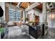 Spacious loft living room featuring concrete floors, exposed brick and ductwork, and large industrial windows at 650 Glen Iris Drive Ne # 27, Atlanta, GA 30308