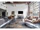 Open concept living space with modern decor, brick accents, and large windows at 650 Glen Iris Drive Ne # 27, Atlanta, GA 30308
