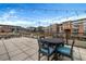 A roof top patio has black outdoor furniture with string lights above at 650 Glen Iris Drive Ne # 27, Atlanta, GA 30308