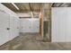 Building storage units with rolling doors, concrete floors, and fluorescent lighting at 650 Glen Iris Drive Ne # 27, Atlanta, GA 30308