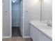 Bathroom showing an open door to a walk-in closet with a white vanity and sink at 7623 Mcgillicuty Dr, Union City, GA 30291