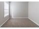 A bright bedroom featuring plush carpeting and a large window at 7623 Mcgillicuty Dr, Union City, GA 30291