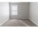 A cozy bedroom featuring plush carpeting and a bright window at 7623 Mcgillicuty Dr, Union City, GA 30291