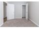 A bedroom with plush carpeting and white doors at 7623 Mcgillicuty Dr, Union City, GA 30291
