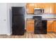 Kitchen with black appliances and wood cabinets at 7623 Mcgillicuty Dr, Union City, GA 30291