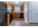 Compact kitchen features black appliances and wood cabinets at 7623 Mcgillicuty Dr, Union City, GA 30291