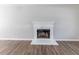 Living room fireplace with white mantle and wood-look flooring at 7623 Mcgillicuty Dr, Union City, GA 30291
