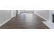 Bright living room with wood-look flooring and view to entry way at 7623 Mcgillicuty Dr, Union City, GA 30291