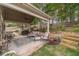 Inviting covered back porch with comfortable seating and a view of the landscaped backyard at 1657 Williams Mill Way, Dacula, GA 30019