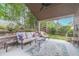 Inviting covered back porch with comfortable seating, a ceiling fan, and a view of the landscaped backyard at 1657 Williams Mill Way, Dacula, GA 30019