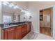 Large bathroom with double sinks, granite countertops, wood cabinets, and a walk-in closet at 1657 Williams Mill Way, Dacula, GA 30019