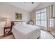 Cozy bedroom with vaulted ceiling, hardwood floors, neutral decor, and a large window for natural light at 1657 Williams Mill Way, Dacula, GA 30019