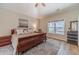 Well-lit bedroom features a ceiling fan, a large window, and a comfortable king bed and tasteful decor at 1657 Williams Mill Way, Dacula, GA 30019