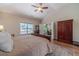 Comfortable bedroom with a king bed, a ceiling fan, and a large window with a view of the outdoors at 1657 Williams Mill Way, Dacula, GA 30019