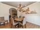 Cozy dining room featuring a round table, chandelier, and decorative wall paneling at 1657 Williams Mill Way, Dacula, GA 30019
