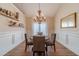 Elegant dining room with a chandelier and decorative wall paneling at 1657 Williams Mill Way, Dacula, GA 30019