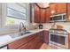 Updated kitchen with stainless steel appliances, granite countertops, and a modern faucet at 1657 Williams Mill Way, Dacula, GA 30019