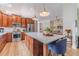 Open kitchen with a large island, stainless steel appliances, wood cabinets and a view to the living room at 1657 Williams Mill Way, Dacula, GA 30019