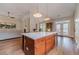 Spacious kitchen with a center island, wood cabinets, and stainless appliances with a view to the back yard at 1657 Williams Mill Way, Dacula, GA 30019