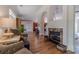 Open living room with a fireplace, hardwood floors, and large windows allowing plenty of natural light at 1657 Williams Mill Way, Dacula, GA 30019