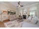 Comfortable living room featuring a fireplace, neutral decor, and abundant natural light at 1657 Williams Mill Way, Dacula, GA 30019