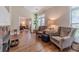 Cozy living room with a fireplace, hardwood floors, comfortable chairs, and a view to the dining room at 1657 Williams Mill Way, Dacula, GA 30019