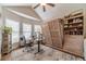 Bright home office with built-in bookshelves, a Murphy bed, hardwood floors, and lots of natural light at 1657 Williams Mill Way, Dacula, GA 30019