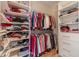 Organized walk-in closet with shelving and hanging racks provides ample storage space for clothing and accessories at 1657 Williams Mill Way, Dacula, GA 30019