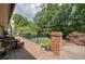 Spacious brick patio with outdoor furniture, overlooking lush backyard with trees at 1890 Silvastone Dr, Decatur, GA 30033