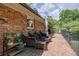 Relaxing brick patio featuring outdoor seating and view of the private backyard at 1890 Silvastone Dr, Decatur, GA 30033