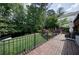 Scenic view of lush backyard with expansive brick patio, landscaping, and trees at 1890 Silvastone Dr, Decatur, GA 30033