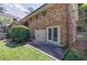 Home exterior featuring a backyard patio, landscaped yard, and brick facade at 1890 Silvastone Dr, Decatur, GA 30033