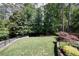 Expansive backyard featuring mature trees and manicured lawn for outdoor entertaining at 1890 Silvastone Dr, Decatur, GA 30033