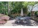 Charming backyard patio with stone retaining wall and landscaped garden area at 1890 Silvastone Dr, Decatur, GA 30033