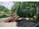 Picturesque backyard view with mature trees, garden area, and play set at 1890 Silvastone Dr, Decatur, GA 30033