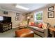 Finished basement with carpet, a couch, and TV at 1890 Silvastone Dr, Decatur, GA 30033