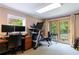 Finished basement featuring exercise equipment, a desk, and French doors leading to the backyard at 1890 Silvastone Dr, Decatur, GA 30033