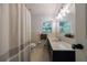 Bathroom with a shower-tub combo, large mirror, and natural light from the window at 1890 Silvastone Dr, Decatur, GA 30033