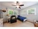 Bright bedroom featuring a single bed, accent chair, and natural light from two windows at 1890 Silvastone Dr, Decatur, GA 30033