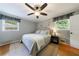 Comfortable bedroom with a ceiling fan, hardwood floors, and windows providing natural light at 1890 Silvastone Dr, Decatur, GA 30033