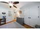 Cozy bedroom with hardwood floors, a ceiling fan, and a view into the hallway at 1890 Silvastone Dr, Decatur, GA 30033