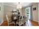Hardwood dining room featuring a dark table, stylish chairs, a gray sideboard, and sheer curtains at 1890 Silvastone Dr, Decatur, GA 30033