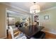 Sun-drenched dining room featuring a dark wood table, stylish chairs, and modern chandelier at 1890 Silvastone Dr, Decatur, GA 30033