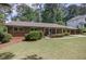 Classic brick home featuring a lush front lawn and established landscaping at 1890 Silvastone Dr, Decatur, GA 30033
