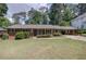 Charming brick home with a well-manicured lawn and inviting curb appeal at 1890 Silvastone Dr, Decatur, GA 30033
