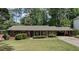 Charming brick home with well-manicured lawn, inviting curb appeal, and convenient covered parking at 1890 Silvastone Dr, Decatur, GA 30033