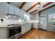 Charming kitchen with white cabinets, stainless appliances, granite countertops, and wooden beam ceiling at 1890 Silvastone Dr, Decatur, GA 30033