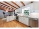 Bright kitchen with white cabinetry, granite counters, stainless steel appliances, and exposed beams at 1890 Silvastone Dr, Decatur, GA 30033