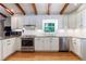 Bright kitchen with white cabinets, stainless steel appliances, granite countertops, and hardwood floors at 1890 Silvastone Dr, Decatur, GA 30033